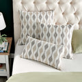 Modern Boyega Pillow in various sizes displayed on a bed with a tufted headboard, creating an elegant and comfortable bedroom decor.
