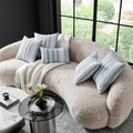 Sophisticated Fountas Pillow styled in a modern living room setup, with multiple pillows in blue and white stripes adorning a beige sofa, creating a cozy and elegant look.