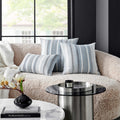 Another angle of the Sophisticated Fountas Pillow in a contemporary living room, featuring a comfortable beige sofa and stylish blue and white striped pillows, enhancing the room's aesthetic.