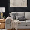 Sophisticated Revamp Pillow styled on a modern gray sofa, adding elegance to a contemporary living room setting.