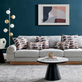 A stylish set of Vibrant Brightside Pillows arranged on a modern grey sofa, highlighting the pillows' bold blue and brown circular patterns against a chic, contemporary living room backdrop.